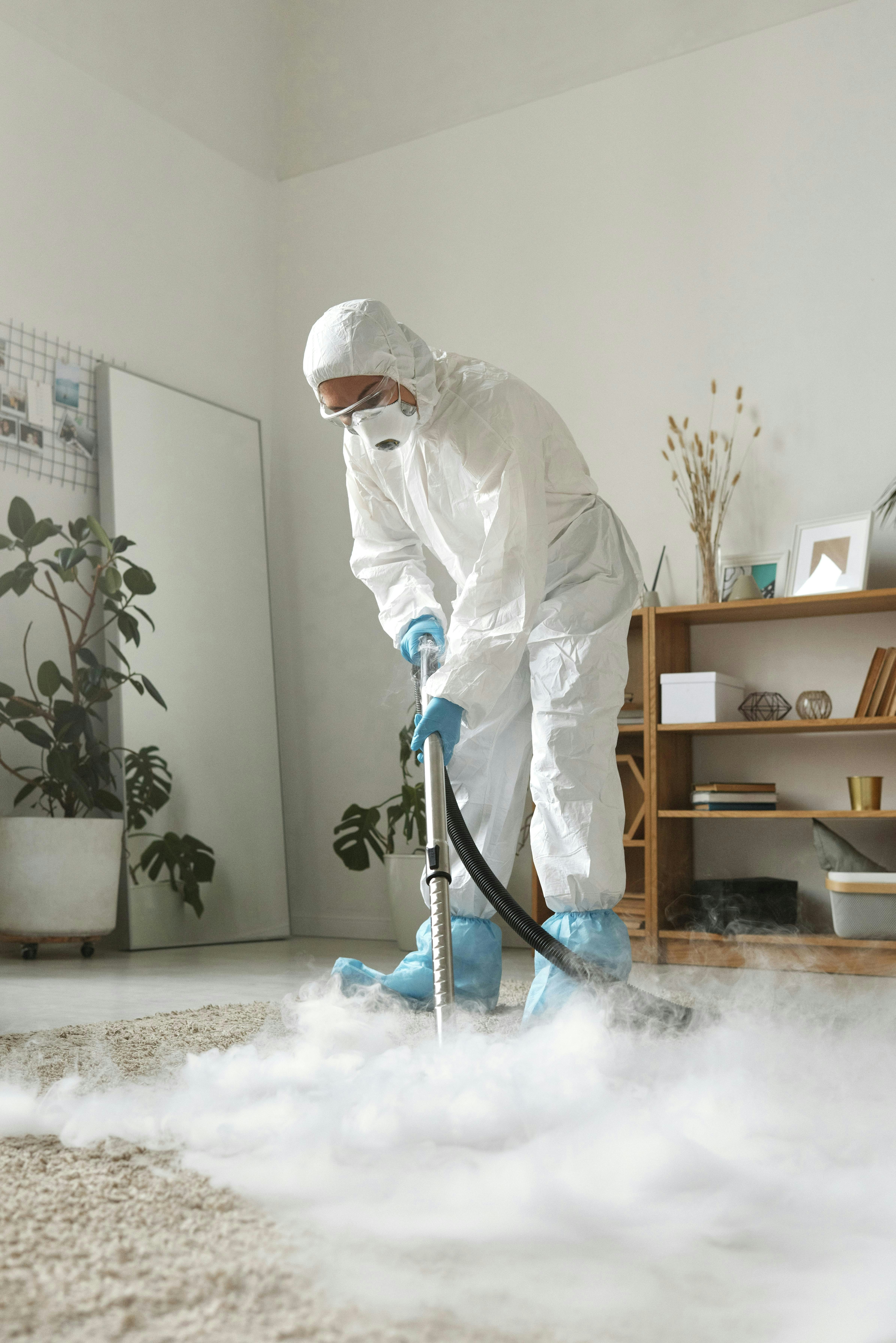 Professional cleaning staff member wiping down a glass surface in a modern office.